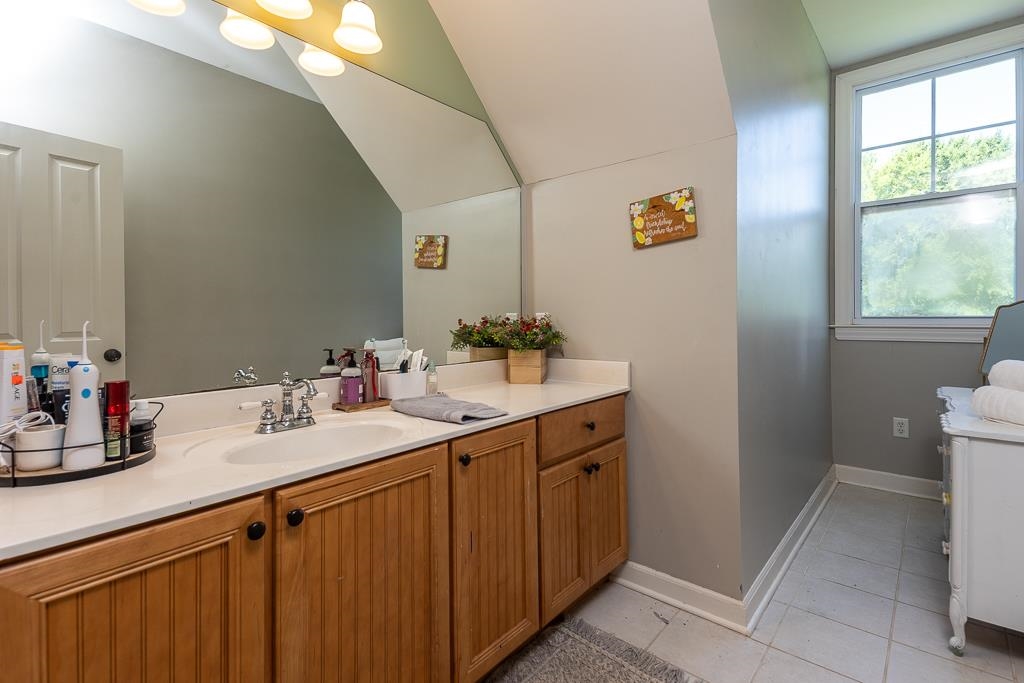 1915 Teague Store Road Somerville, TN 38068 - Photo 34 of 38 Bathroom vanity featuring a single sink, light-toned countertop, and wood-panel cabinetry