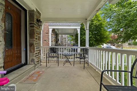 a view of a porch with a table and chairs