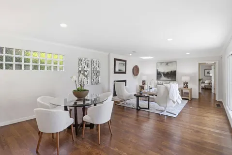 a view of a dining room with furniture and wooden floor