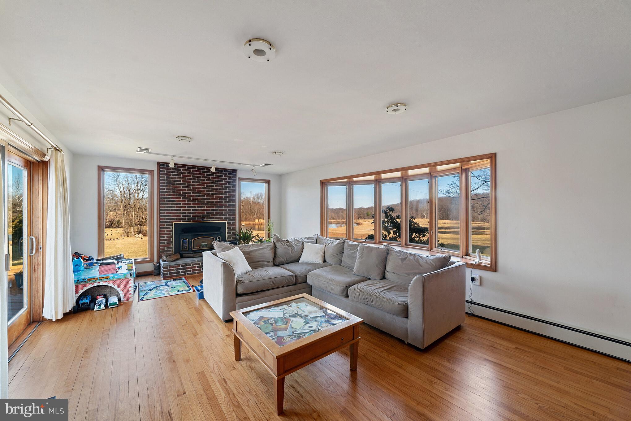 3125 West Ivory Road West Friendship, MD 21794 - Photo 12 of 30 Living room with fireplace and views of pond