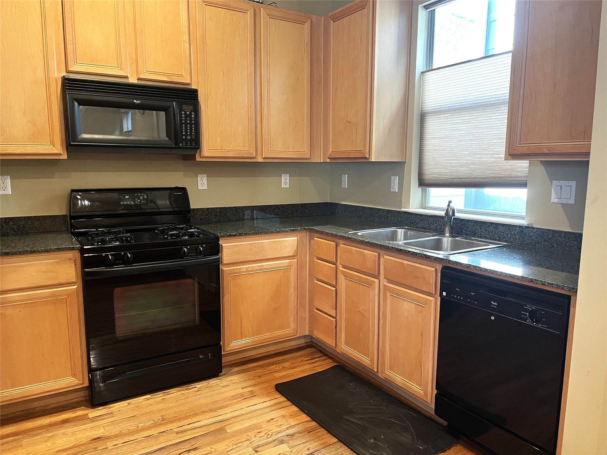 4338 Center Street Houston, TX 77007 - Photo 11 of 23 a kitchen with granite countertop a stove top oven microwave and cabinets