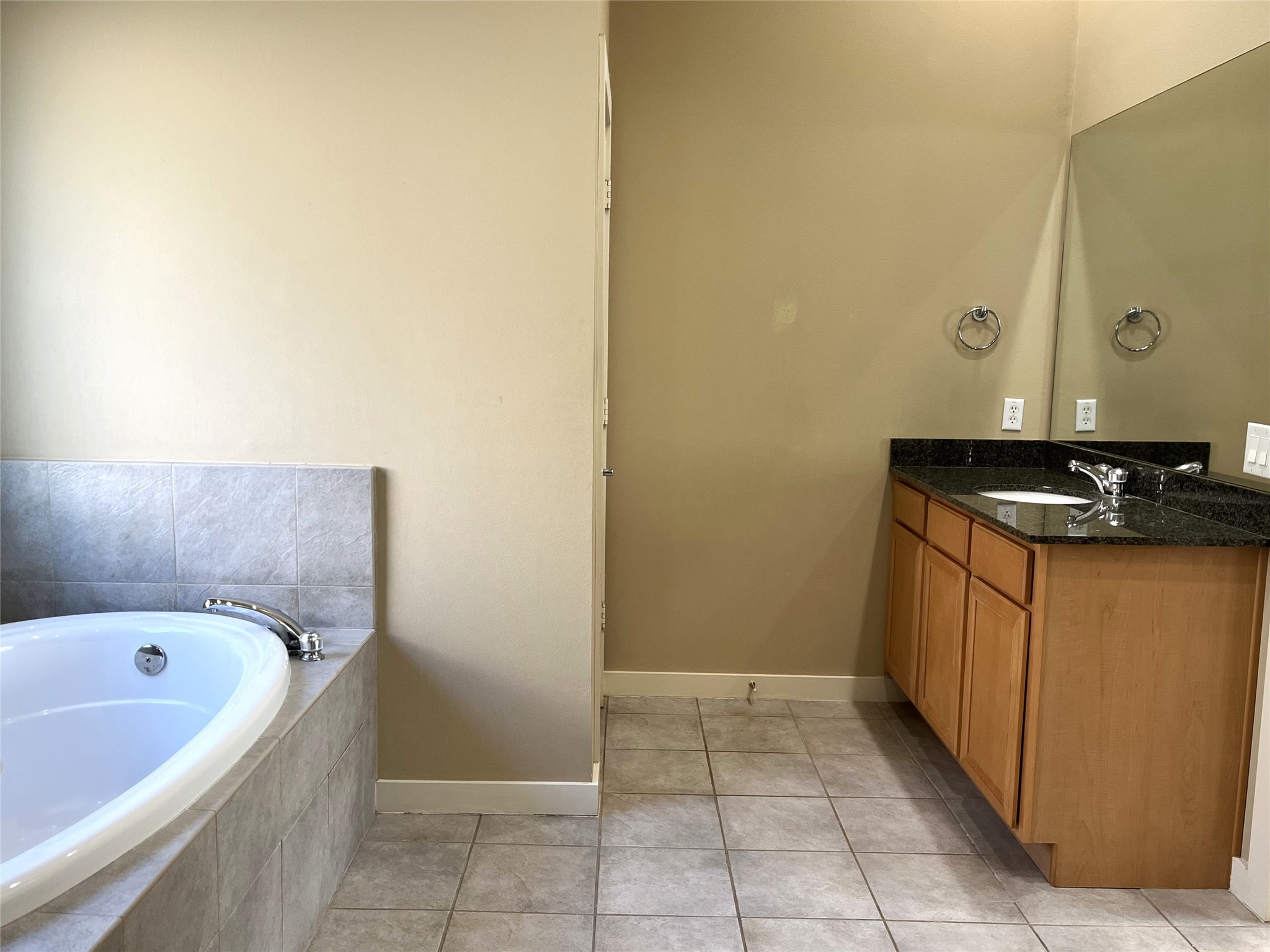 4338 Center Street Houston, TX 77007 - Photo 20 of 23 a bathroom with a granite countertop sink and a bathtub