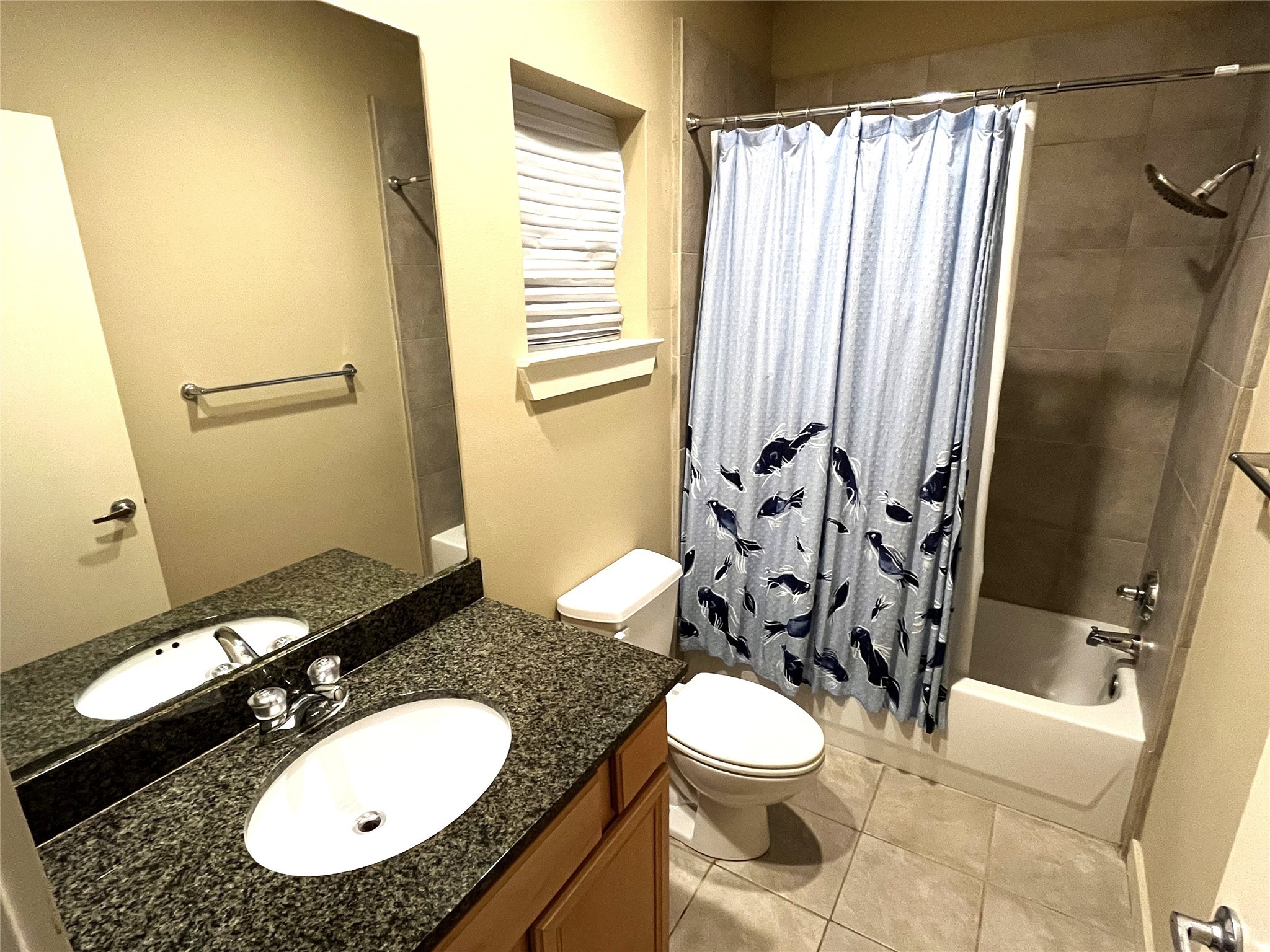 4338 Center Street Houston, TX 77007 - Photo 6 of 23 a bathroom with a granite countertop toilet sink and mirror