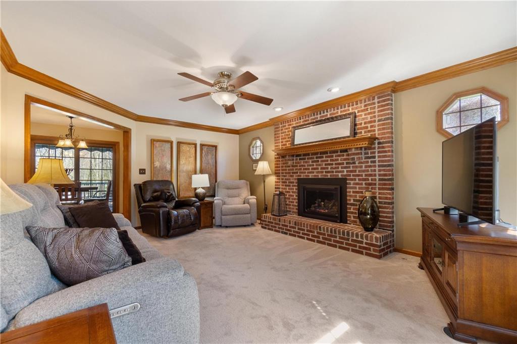 116 Firethorn Road Baden, PA 15005 - Photo 12 of 41 a living room with furniture a fireplace and a flat screen tv