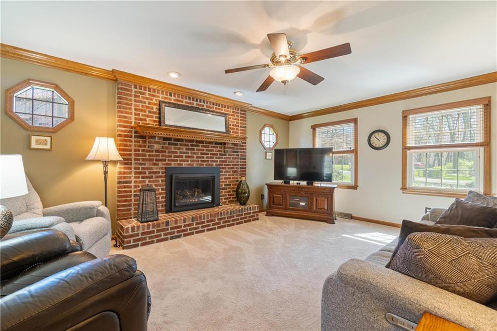 116 Firethorn Road Baden, PA 15005 - Photo 13 of 41 a living room with furniture a flat screen tv and a fireplace