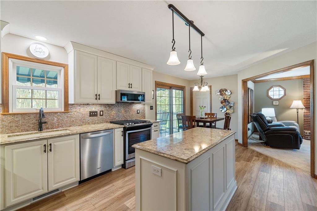 116 Firethorn Road Baden, PA 15005 - Photo 18 of 41 a kitchen with stainless steel appliances granite countertop a sink a stove and a wooden floors
