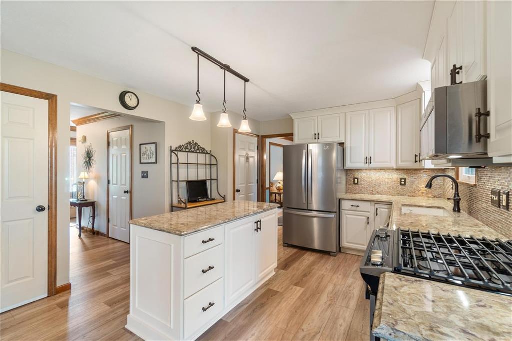 116 Firethorn Road Baden, PA 15005 - Photo 19 of 41 a kitchen with a refrigerator a sink and wooden floor