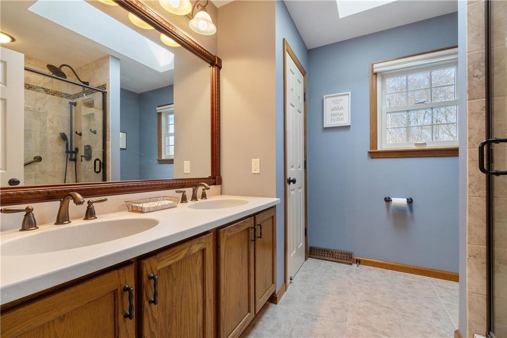 116 Firethorn Road Baden, PA 15005 - Photo 30 of 41 a bathroom with a sink and a mirror