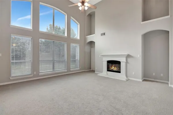 a view of a livingroom with a fireplace and a window