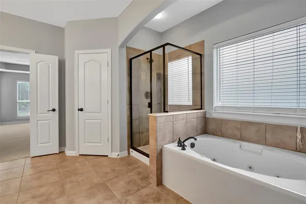 a bathroom with a bathtub and a shower