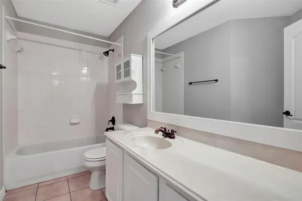 a bathroom with a sink toilet a shower and a mirror