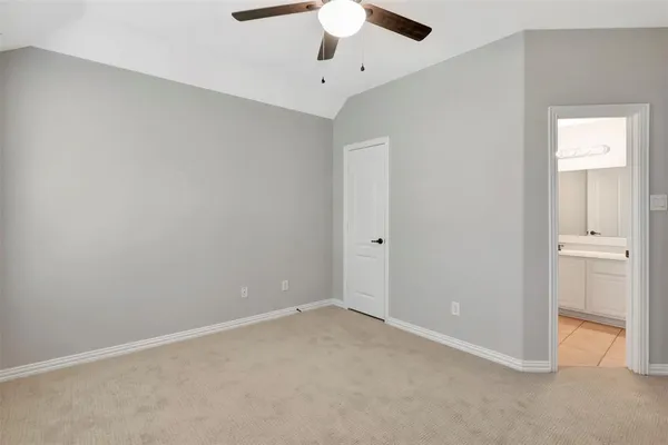 an empty room with a ceiling fan and a window