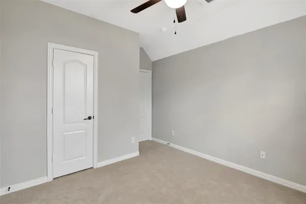 an empty room with a empty space and a ceiling fan