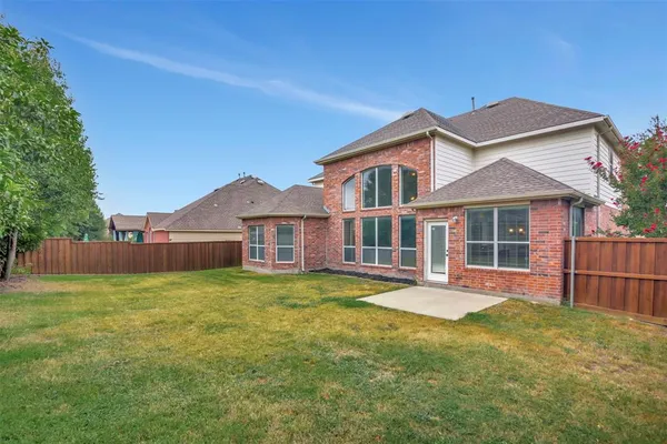 a front view of a house with a yard and porch
