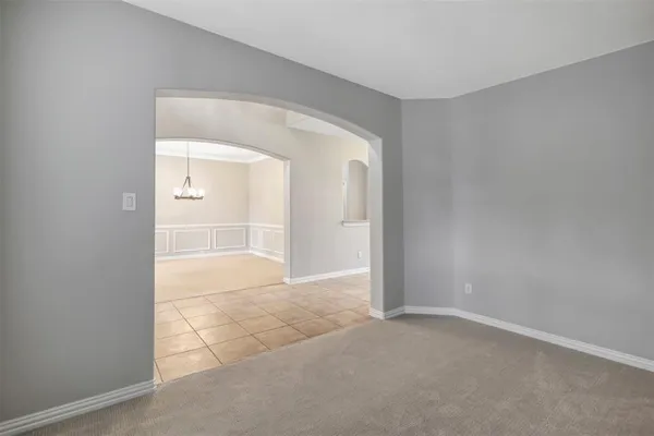 an empty room with cabinet and mirrors