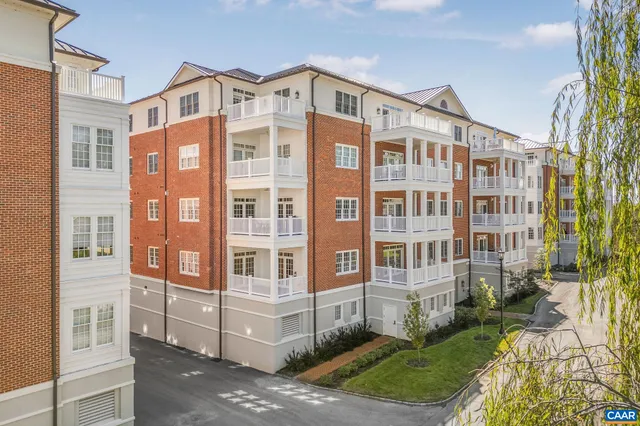 a front view of a building with a garden