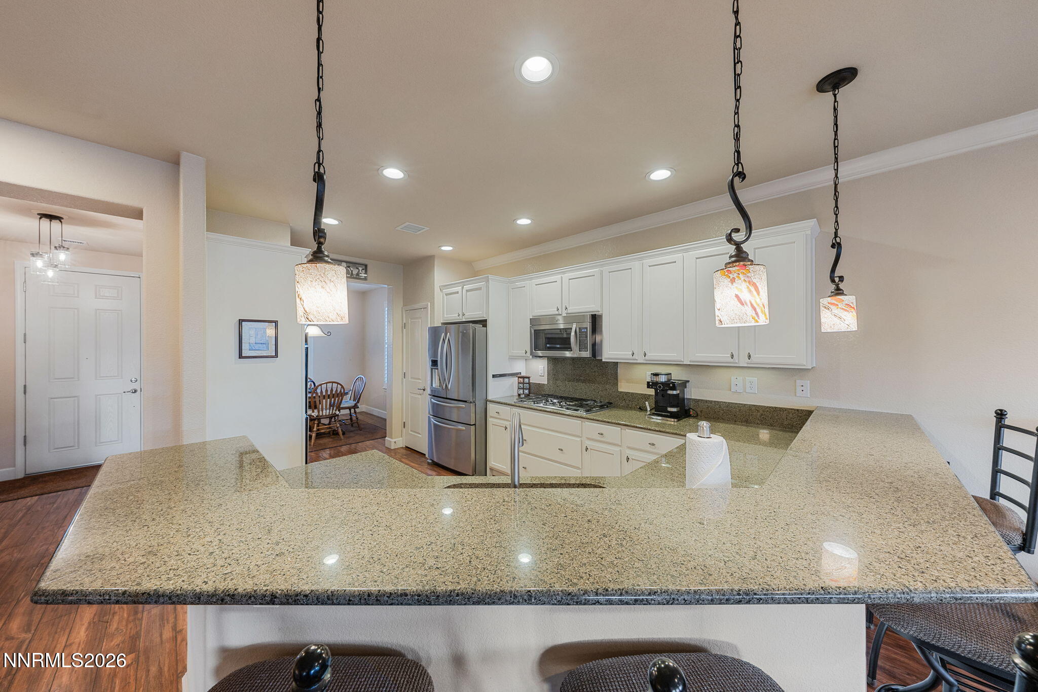 9370 Rockhurst Court Reno, NV 89523 - Photo 12 of 40 a large kitchen with kitchen island a large counter space a sink stainless steel appliances and cabinets
