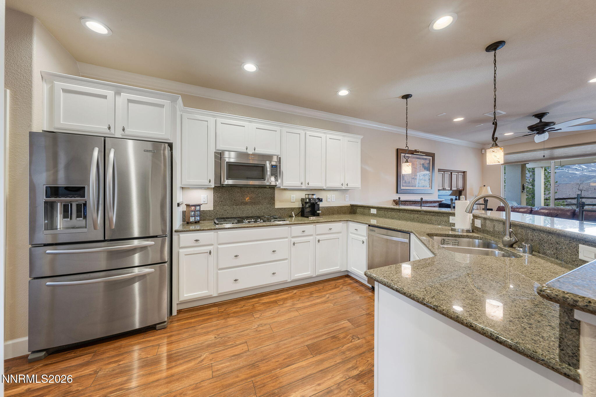 9370 Rockhurst Court Reno, NV 89523 - Photo 16 of 40 a kitchen with stainless steel appliances granite countertop a refrigerator a stove a sink dishwasher and a refrigerator with wooden floor