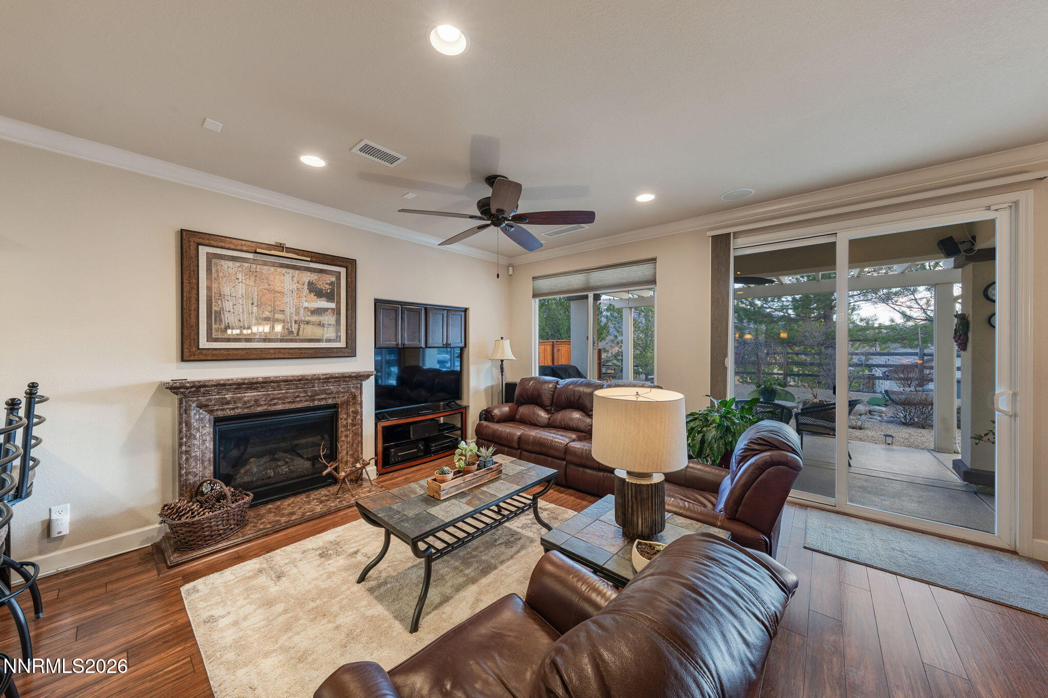9370 Rockhurst Court Reno, NV 89523 - Photo 23 of 40 a living room with furniture a fireplace and a floor to ceiling window