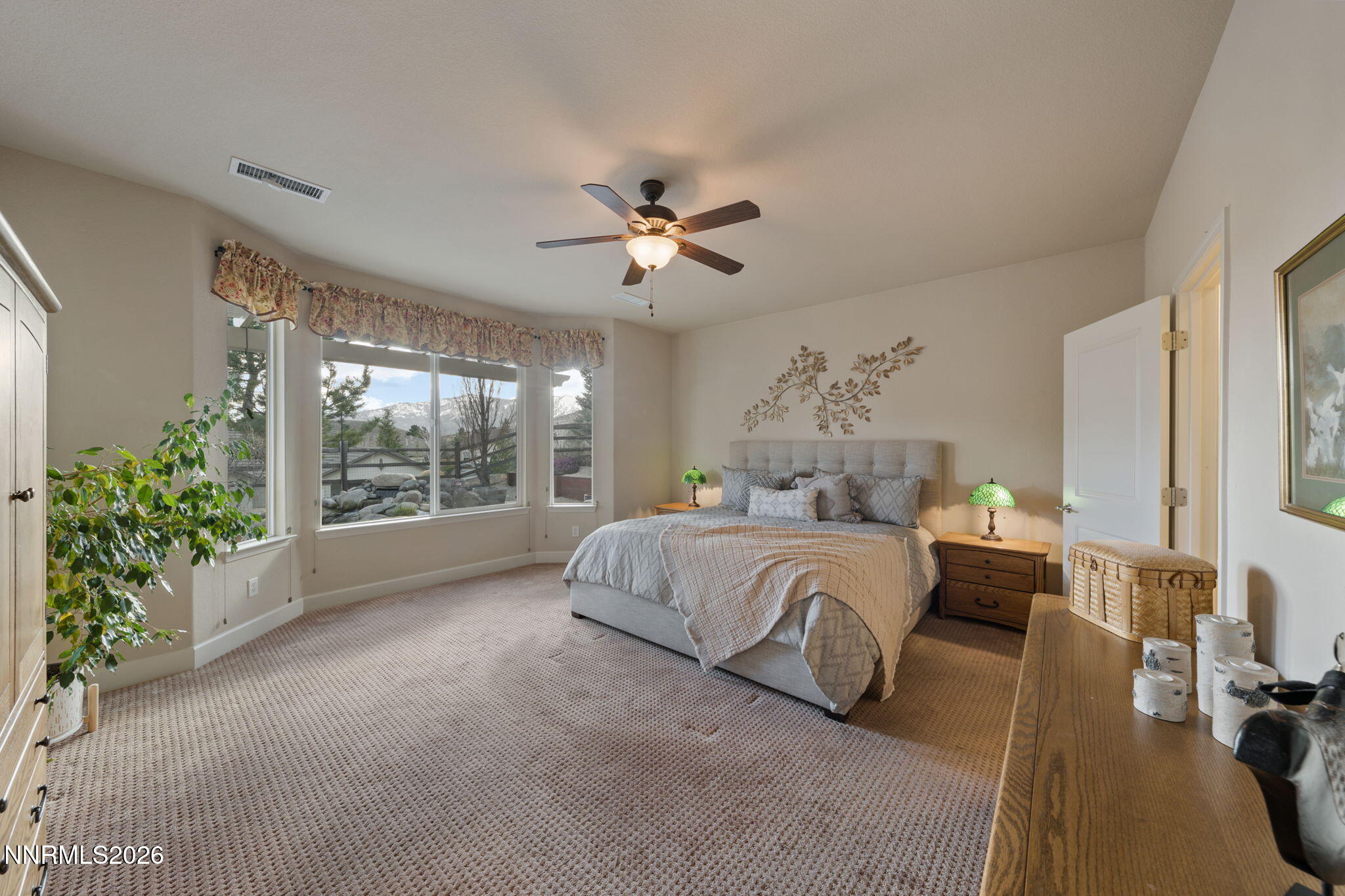9370 Rockhurst Court Reno, NV 89523 - Photo 28 of 40 a spacious bedroom with a bed and a chandelier