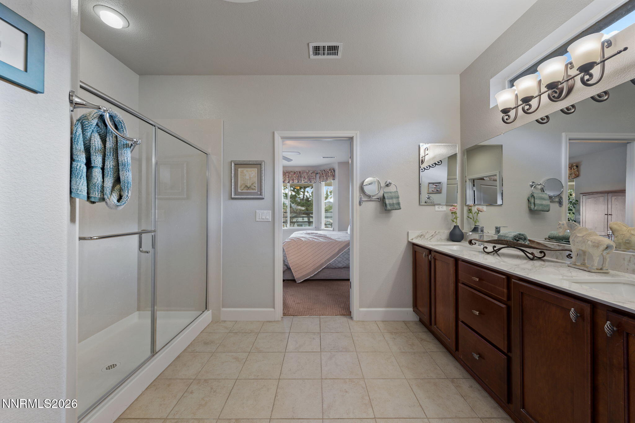 9370 Rockhurst Court Reno, NV 89523 - Photo 30 of 40 a bathroom with a double vanity sink mirror and shower