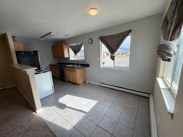 a kitchen with stainless steel appliances granite countertop a sink and cabinets