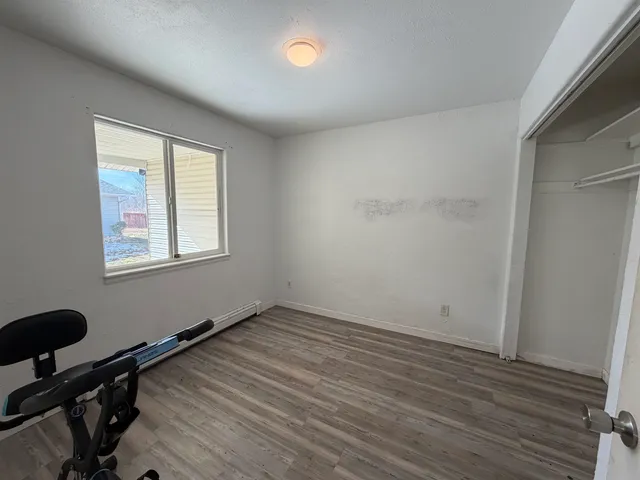 a view of a room with wooden floor and a sink