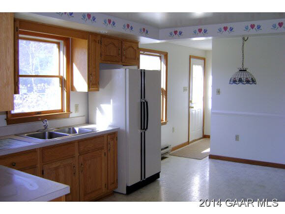 3694 Shutterlee Mill Road Staunton, VA 24401 - Photo 9 of 17 a kitchen with cabinets a window and stainless steel appliances