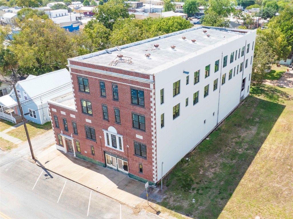 607 Lyons Avenue Schulenburg, TX 78956 - Photo 3 of 27 a view of a white building with a yard