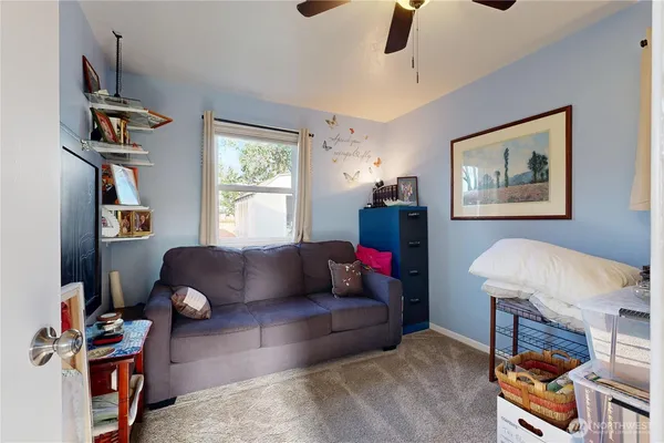 a bathroom with a sink and a washing machine with wooden floor