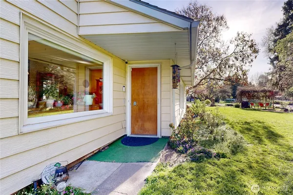 a view of a house with a backyard and a garden