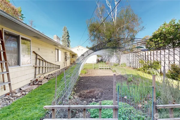a view of a house with a yard and sitting area