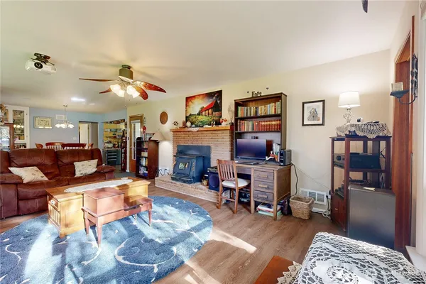 a dining room with furniture window and wooden floor
