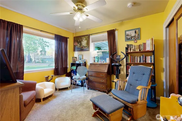 a bedroom with a bed and a book shelf