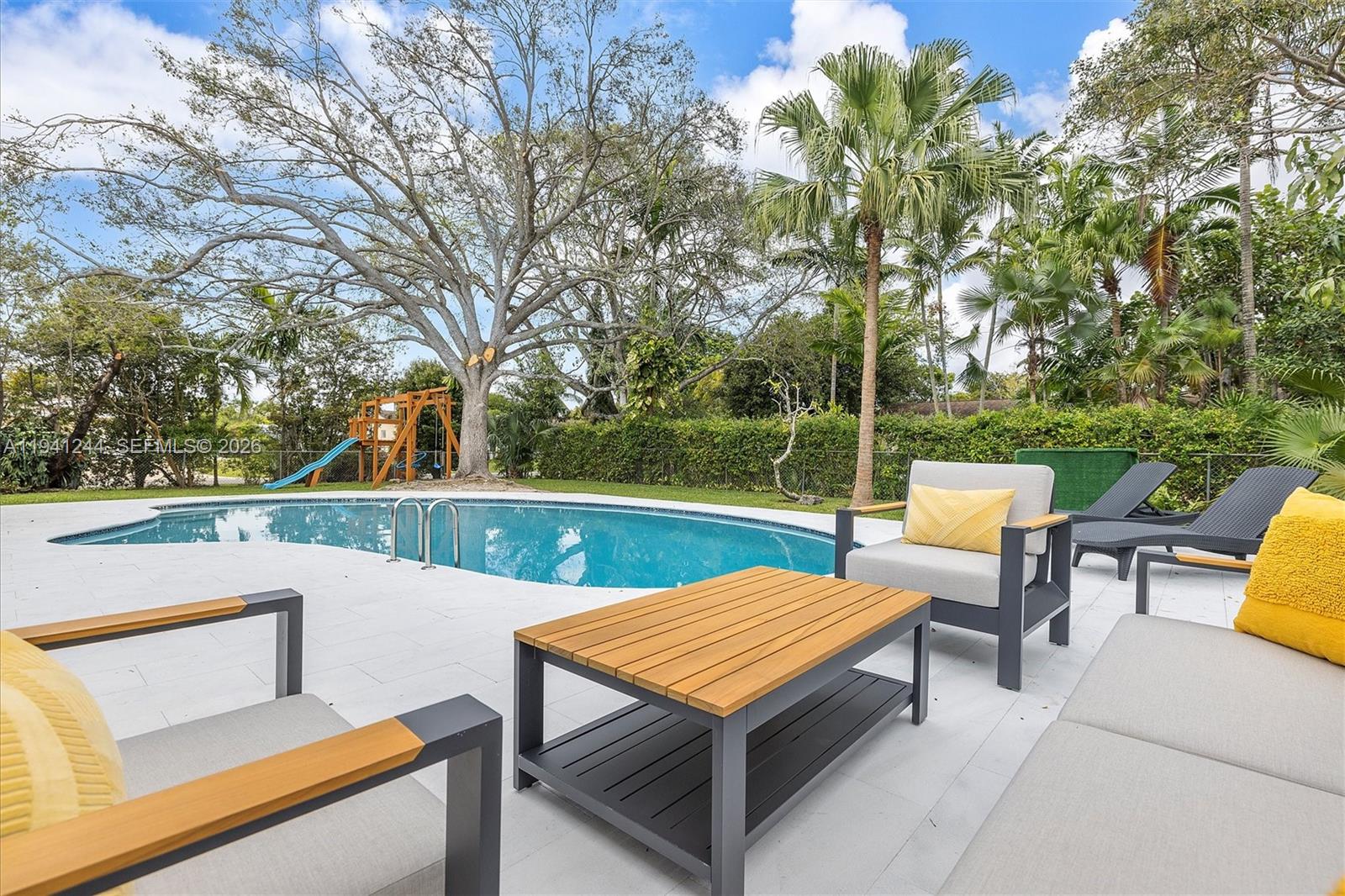a view of a yard with sitting area