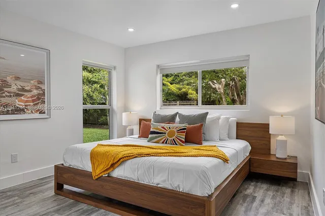 a bedroom with a bed and a large window