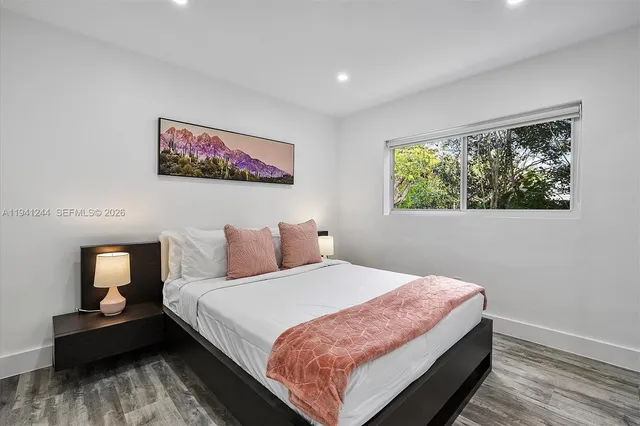 a bedroom with bed and a window