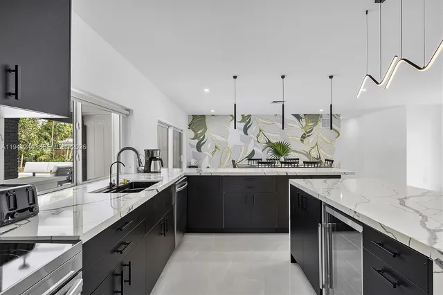 a kitchen with stainless steel appliances granite countertop sink stove and cabinets