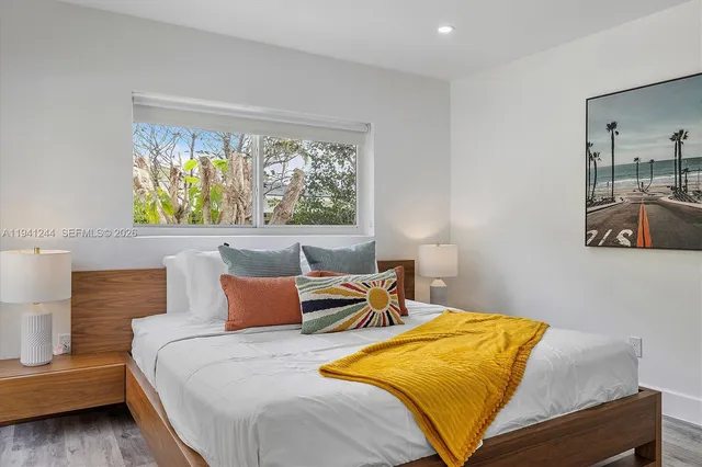 a bedroom with a bed and window