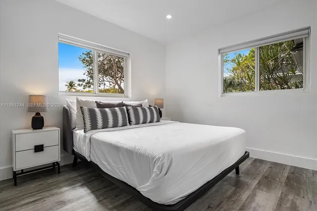 a bedroom with a bed and a painting on the wall