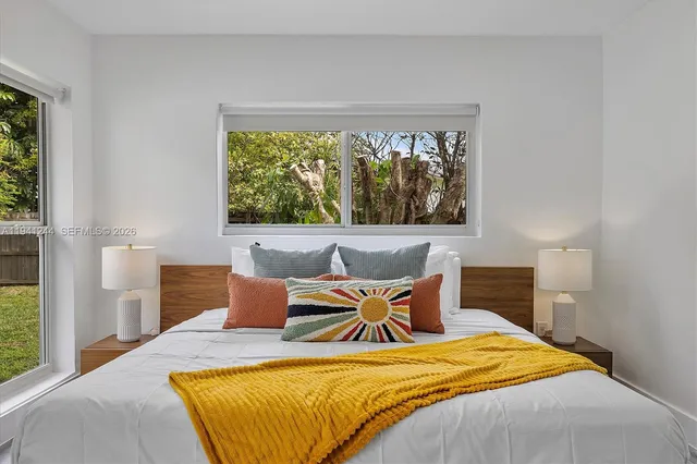 a bedroom with bed and window