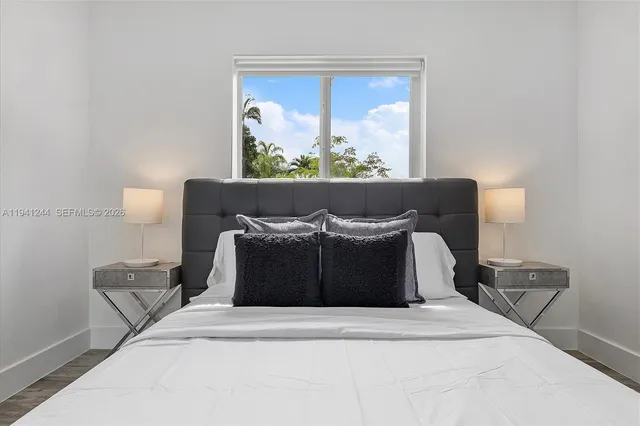 a bed sitting in a bedroom and lamp