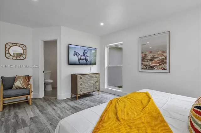 a bedroom with a bed and a couch