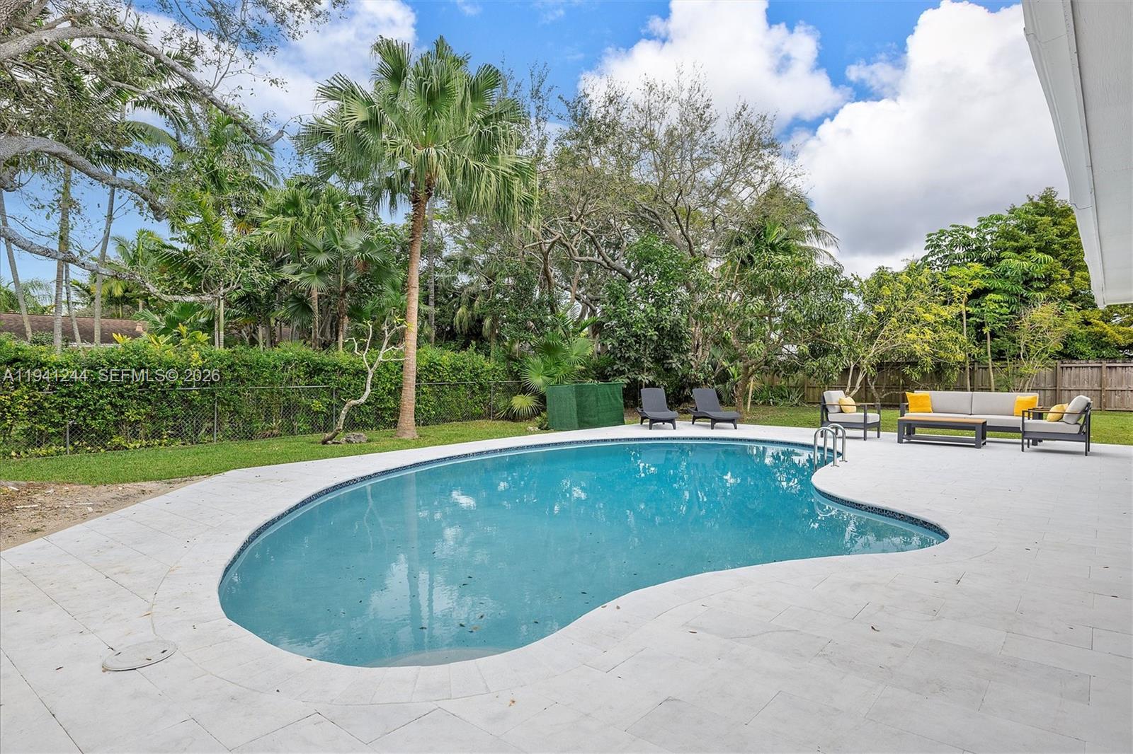 10361 Southwest 119th Street Miami, FL 33176 - Photo 26 of 38 a view of a swimming pool with a patio