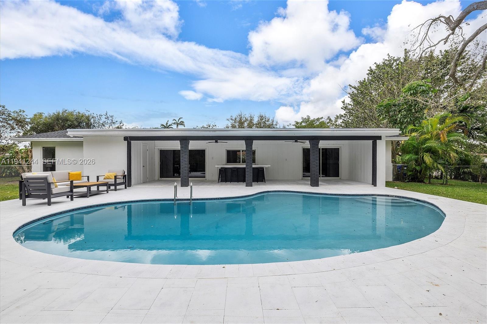 10361 Southwest 119th Street Miami, FL 33176 - Photo 28 of 38 a view of a house with swimming pool and a yard