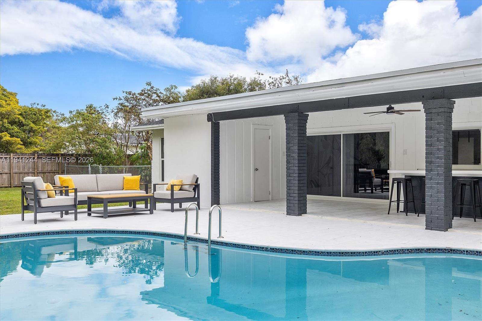 10361 Southwest 119th Street Miami, FL 33176 - Photo 29 of 38 a swimming pool with outdoor seating and yard in the back