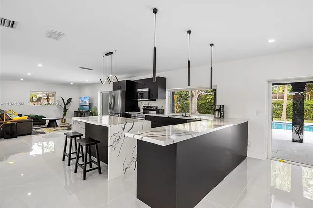 a large kitchen with lots of counter space and furniture