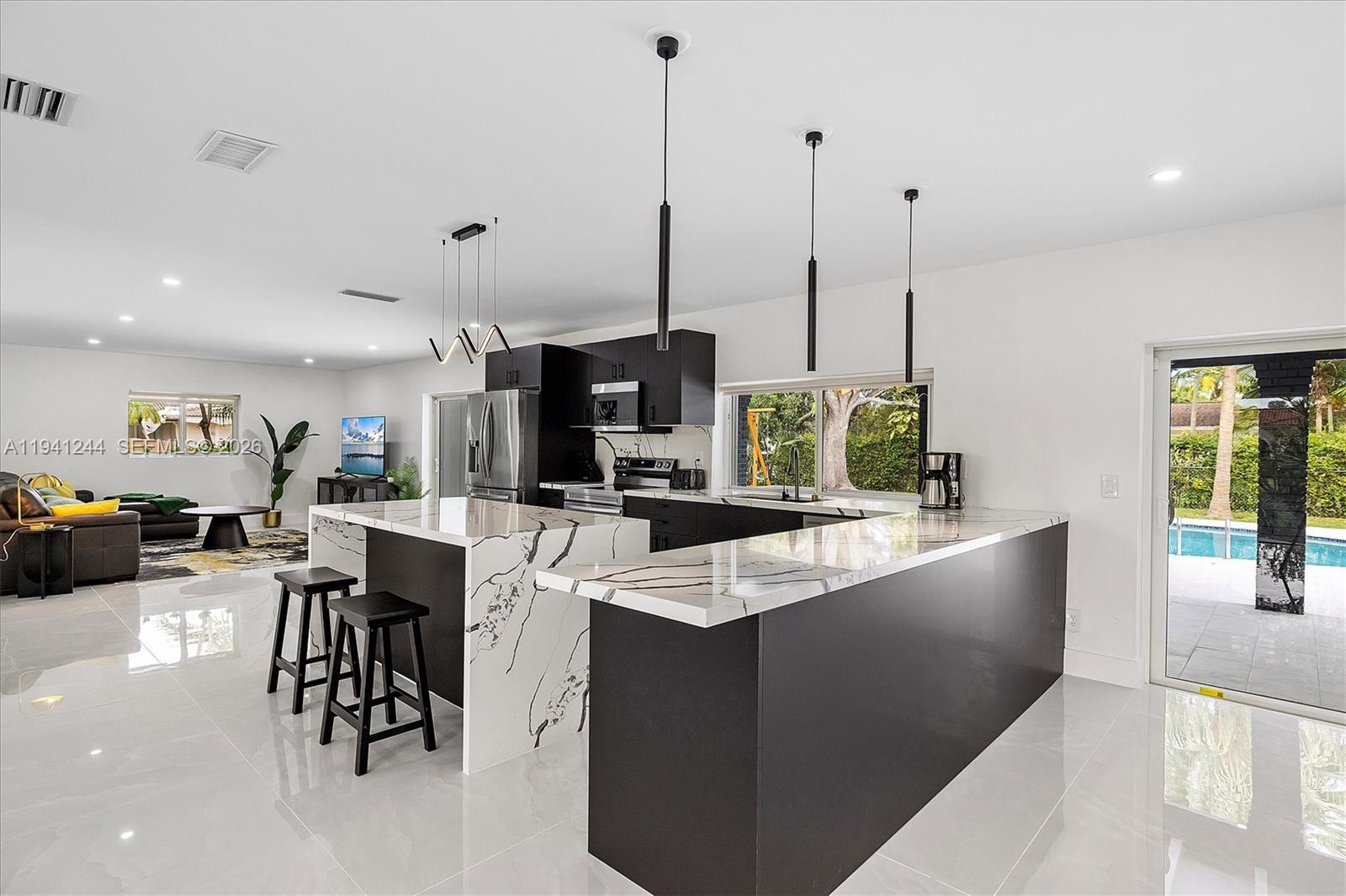 10361 Southwest 119th Street Miami, FL 33176 - Photo 3 of 38 a large kitchen with lots of counter space and furniture