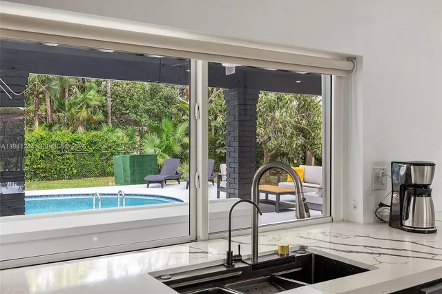 a view of a living room and floor to ceiling window