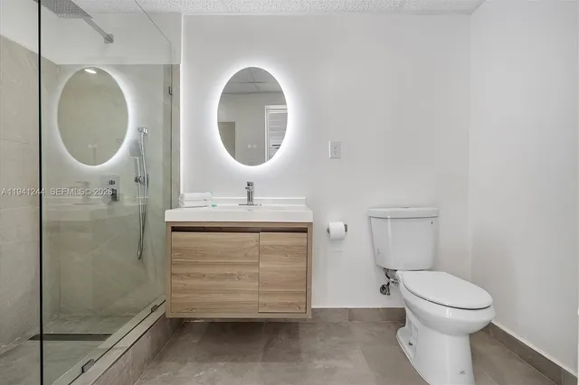 a bathroom with a toilet sink and a mirror